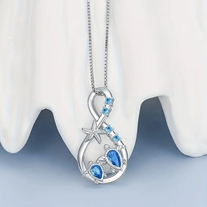 Elegant silver sea turtle pendant necklace with infinity symbol and blue crystals
