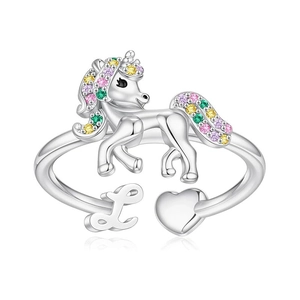 Detail of unicorn ring featuring colorful cubic zirconia stones and letter L charm