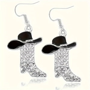 Macro shot of western style cowboy hat and rhinestone encrusted boots earrings