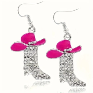 Close-up of pink cowboy hat and rhinestone boot earrings with a mirror reflection
