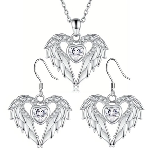 Detailed view of silver heart jewelry set with angel wings and sparkling zircon stones