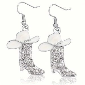 Detail view of silver western boot earrings with rhinestones and white enamel cowboy hat
