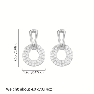 Detail view of silver hollow hoop earrings with white zircon showing size and weight
