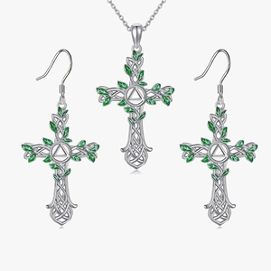 Detailed macro view of the celtic cross jewelry set with green leaf enamel details