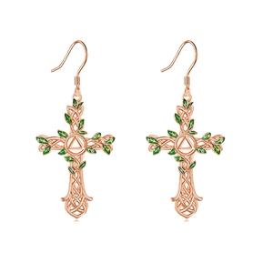 Detail of rose gold tree of life cross earrings with green enamel leaves and Celtic knots