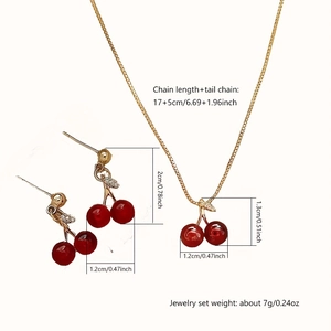 Detail view of red cherry jewelry set with dimensions of necklace and earrings