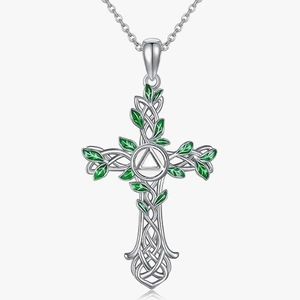 Celtic cross necklace with silver vine design and green enamel leaves on white background
