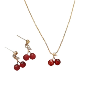 Elegant gold cherry jewelry set featuring red bead necklace and matching hook earrings