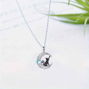 Silver crescent moon necklace with black cat pendant and blue moonstone star detail