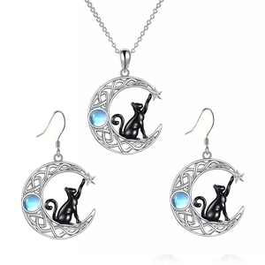 Detail of silver cat and moon jewelry set featuring a blue gemstone and Celtic knots