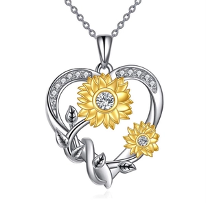 Close-up of heart-shaped sunflower pendant necklace with sparkling gems and yellow enamel