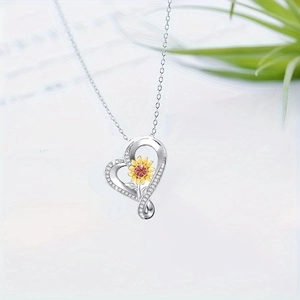 Silver heart sunflower pendant necklace with red gemstone and sparkling zircons