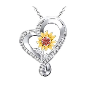 Macro view of heart sunflower pendant with crystal border and red center gemstone