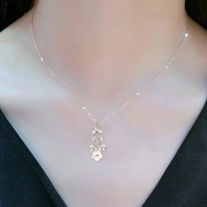 Elegant cherry blossom necklace in rose gold finish with zircon leaves on model