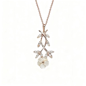 Detail of rose gold necklace featuring a shell cherry blossom and marquise-cut crystal leaves