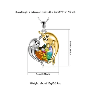 Detailed view of narwhal dolphin pendant with heart crystal and size specifications