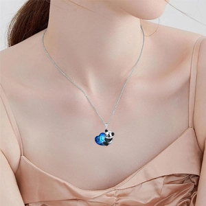 Panda necklace with blue heart crystal pendant on a silver chain worn by a model