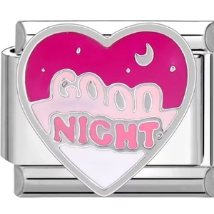 Detail of a heart-shaped stainless steel charm with pink enamel and Good Night text