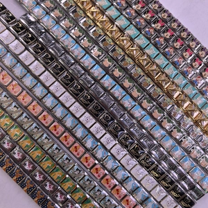 Detailed close-up of modular stainless steel charm links with teacher and 007 patterns
