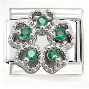 Detailed macro view of Italian charm link featuring a floral design with green gemstones