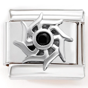 Macro detail of Italian charm link with black gemstone and sunburst design in steel