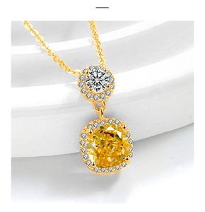Macro shot of gold cushion-cut yellow gemstone necklace with a brilliant halo setting
