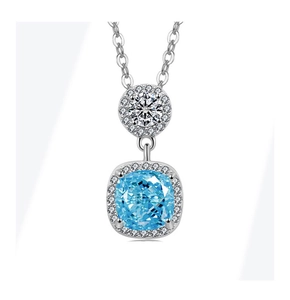 Detail of cushion cut blue gemstone necklace with halo setting and white zircon accent