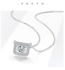 Detailed close-up of square ice-cut pendant necklace with shimmering halo stones