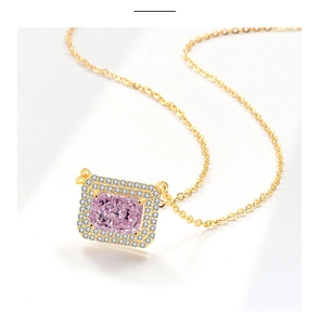 Macro detail of rectangle pink gemstone necklace with gold chain and zircon halo