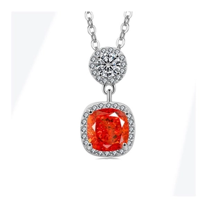 Macro detail of cushion-cut orange-red gemstone necklace with halo diamond setting