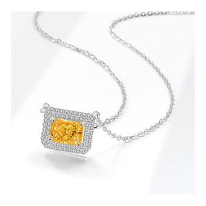 Macro shot of silver necklace with a rectangular yellow gemstone and halo crystal setting