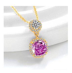 Detailed macro view of a gold necklace featuring a cushion-cut pink gemstone pendant