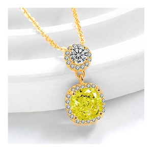 Detailed macro view of gold double pendant necklace with yellow cushion cut gemstone