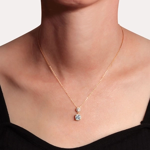Elegant gold chain necklace with double cushion-cut halo crystal pendants on a model