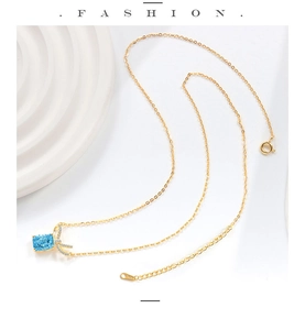 Detail of S925 silver necklace featuring a square blue gem and diamond bow pendant