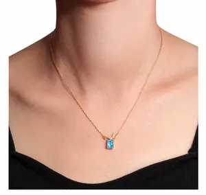 Detail of S925 silver necklace featuring a blue square gemstone and a bow pendant