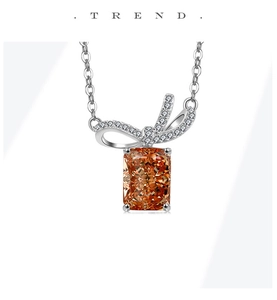 Close-up of S925 silver necklace with orange-brown square gemstone and diamond bow