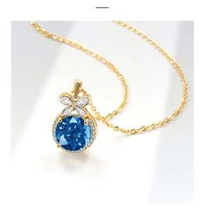 Close-up of a blue sapphire-style pendant with a bow design and gold-plated chain