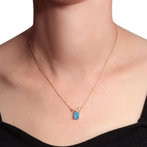 Elegant gold S925 silver necklace featuring a blue square pendant and bow detail on model