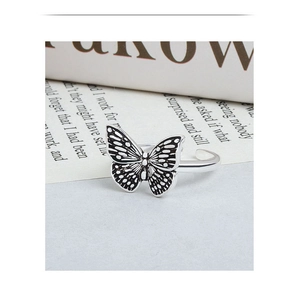 Macro shot of an adjustable butterfly ring with vintage black and white textures