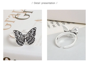 Detailed macro view of vintage silver butterfly ring with adjustable open band structure