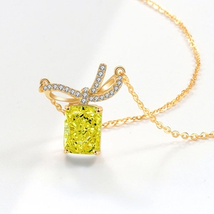 Golden necklace with bow design and rectangular yellow gemstone pendant for women