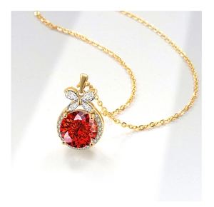 Detail of flower cut red gemstone necklace with butterfly zircon setting in gold finish
