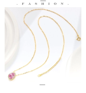 Close-up of S925 sterling silver stamp on golden chain with pink pear-cut stone pendant