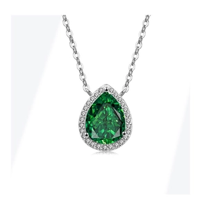 Macro shot of S925 silver pear-shaped emerald pendant with a halo of small white stones