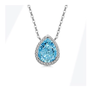 Macro shot of S925 silver necklace with pear-shaped blue gemstone and halo diamonds