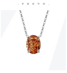Detailed close-up of a silver necklace featuring an oval orange gemstone in four-prong setting