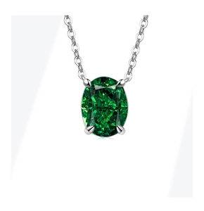 Macro detail of oval green gemstone pendant necklace with a silver four-claw setting