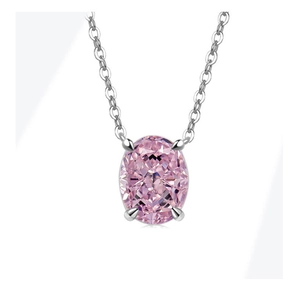 Macro shot of oval pink gemstone pendant in four-prong silver setting with cable chain