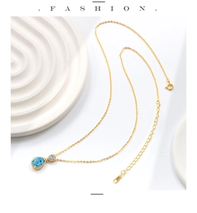 Detail showing S925 hallmark on a gold-plated necklace with a blue teardrop pendant